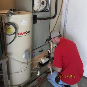 Team member working on a furnace, Bill's Heating and Air Conditioning. Lincoln, NE