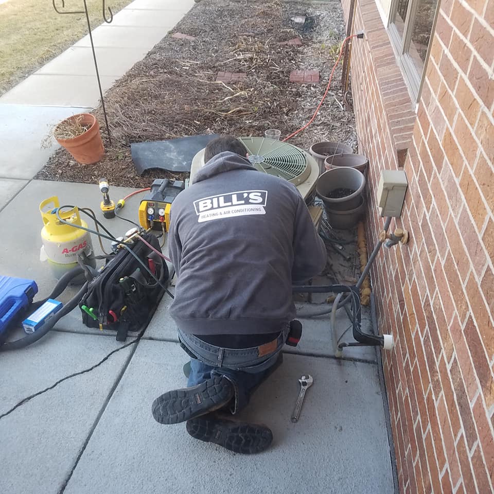 HVAC Service Contract Tech working on equipment for BIll's Heating and Air Conditioning, Lincoln