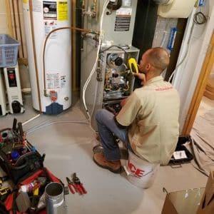 Tech from Bill's working on a furnace repair